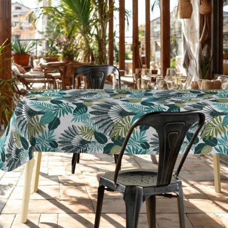 Toile cirée tropicale aux larges feuilles exotiques vertes et bleutées, ambiance jungle élégante.