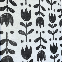 Tissu laminé au mètre Théa, au motif floral noir et blanc au style graphique et épuré