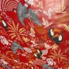 Toile cirée au mètre Anjali rouge, un motif vivant et exotique, des toucans colorés et des feuillages tropicaux