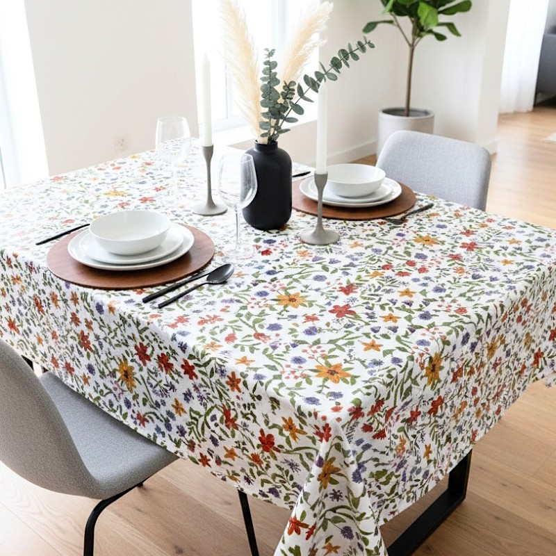 Toile cirée au mètre Renée, motif de fleurs sauvages avec des touches de rouge, jaune et violet viennent illuminer l'ensemble